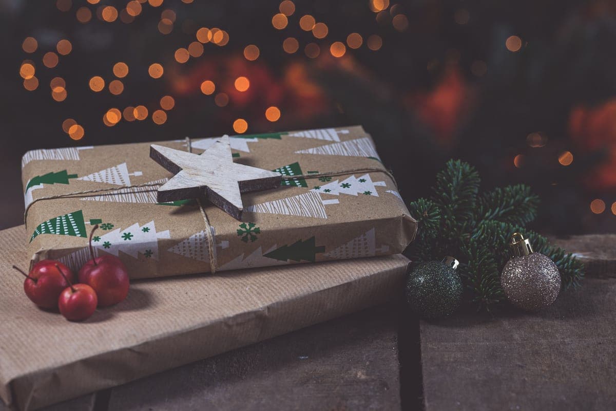 Gifts wrapped in festive paper on a rustic wooden table